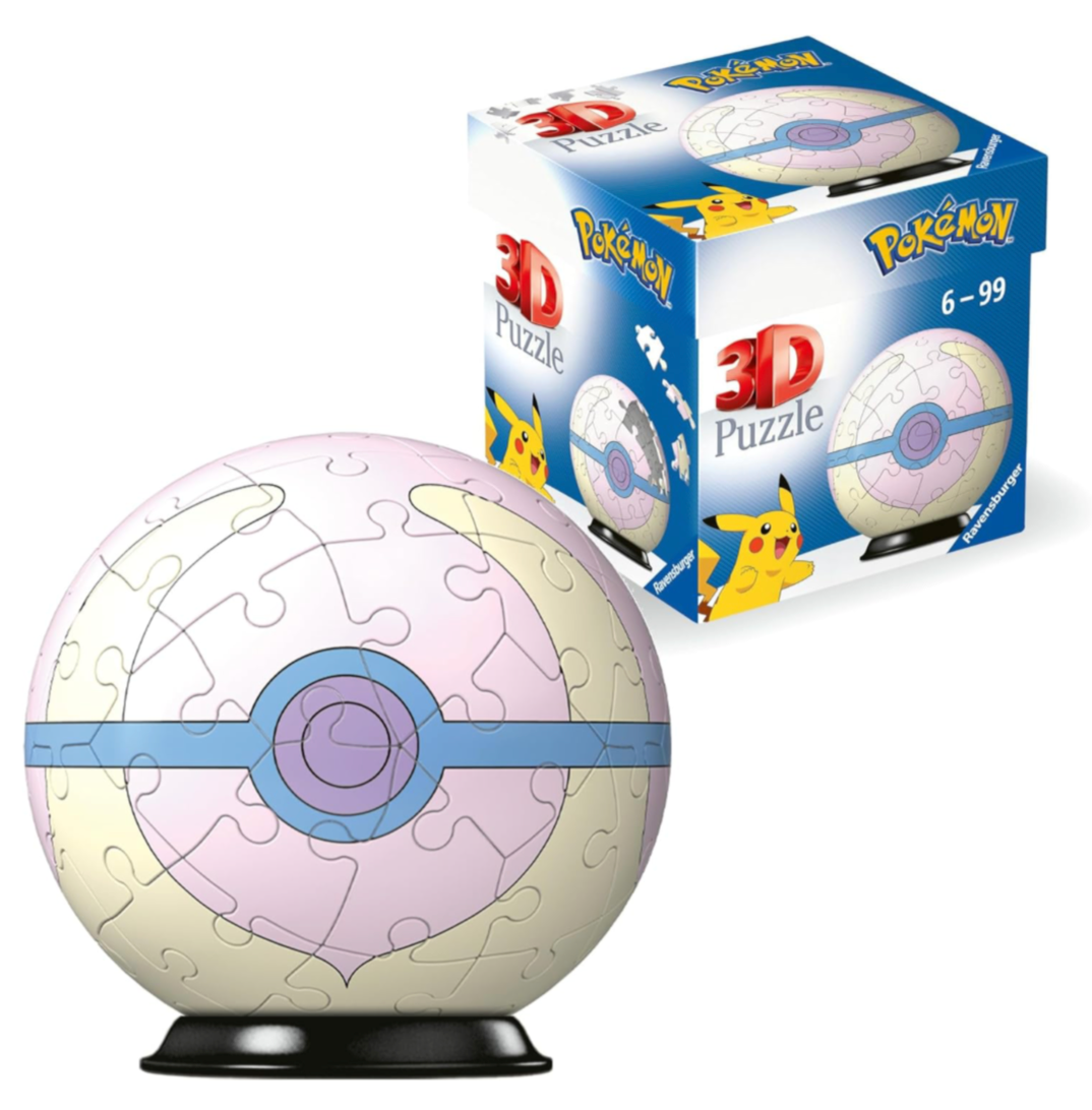Image of a Pokémon-themed 3D puzzle sphere next to its packaging box. The sphere is designed to resemble a Poké Ball with a light pink and white color scheme and a blue band around the middle, resembling the Love Ball design. The puzzle sits on a black stand. The packaging box in the background displays the same Poké Ball design and features the Pokémon logo along with the text '3D Puzzle' in large letters. A Pikachu illustration is visible on the front of the box, and the box indicates the puzzle is suitab